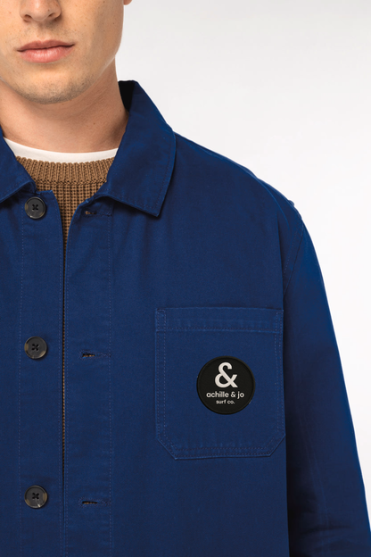 veste workwear bleue portée – gros plan avec patch brodé Achille & Jo